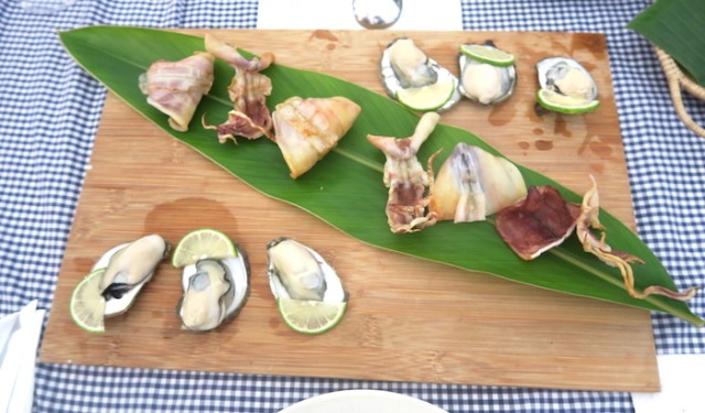 A platter of dried squid and six oysters