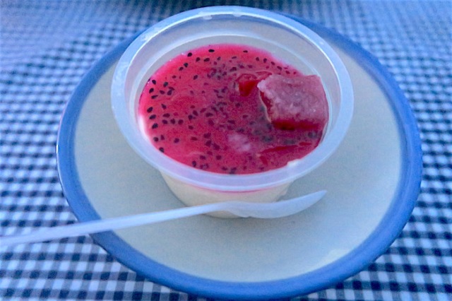 A white dessert pudding made in Nanliao with a bright pink cactus sauce